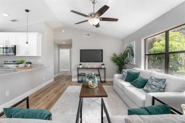 3117 Pine Tree Dr, Edgewater, FL 32141 - living room with light wood-style flooring, vaulted ceiling, ceiling fan, and recessed lighting