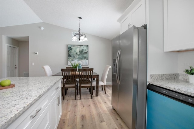 3117 Pine Tree Dr, Edgewater, FL 32141 - kitchen with dishwashing machine, stainless steel fridge, lofted ceiling, light wood-type flooring, and white cabinetry