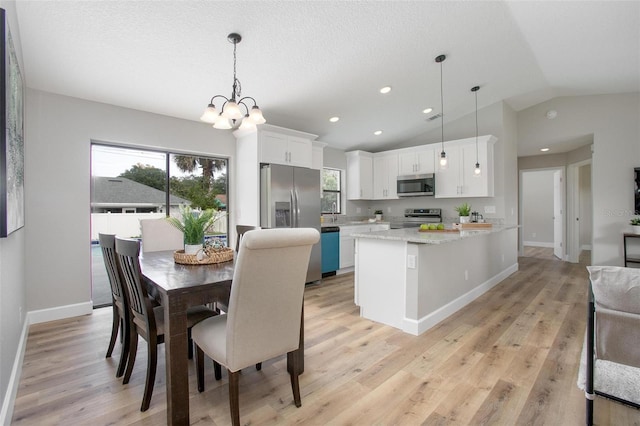 3117 Pine Tree Dr, Edgewater, FL 32141 - dining room featuring healthy amount of natural light, vaulted ceiling, light wood-style flooring, a chandelier, and recessed lighting