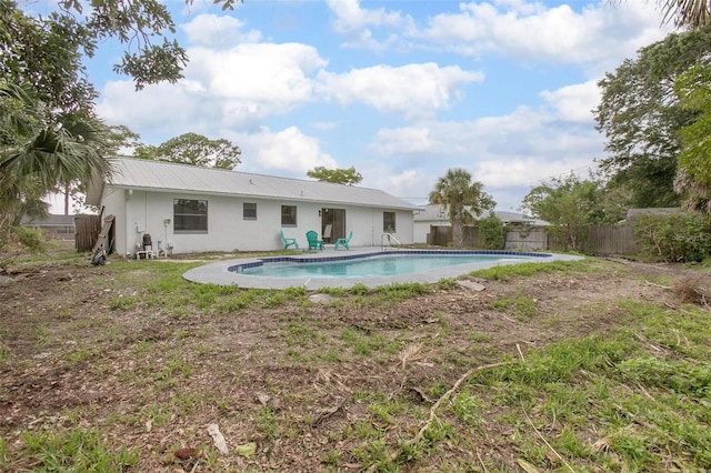 3117 Pine Tree Dr, Edgewater, FL 32141 - rear view of property with a fenced backyard, a metal roof, and stucco siding