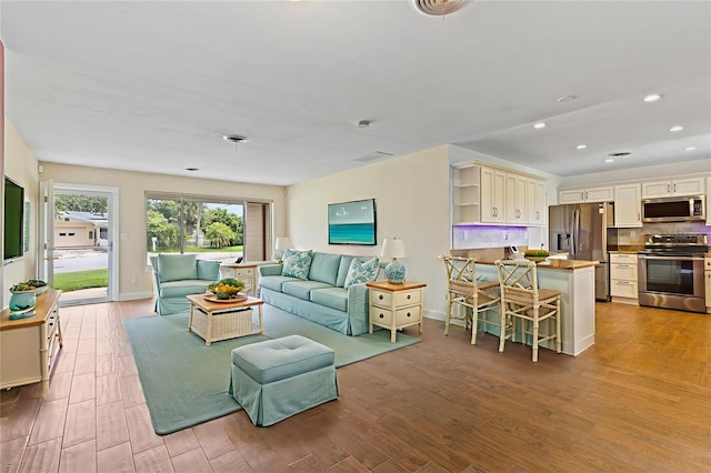 10 Venetian Cir, Port Orange, FL 32127 - living area featuring wood finished floors and recessed lighting