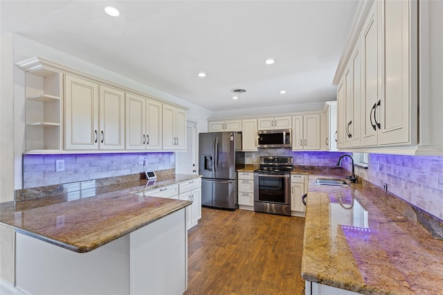 10 Venetian Cir, Port Orange, FL 32127 - kitchen with appliances with stainless steel finishes, open shelves, light stone counters, a peninsula, and decorative backsplash