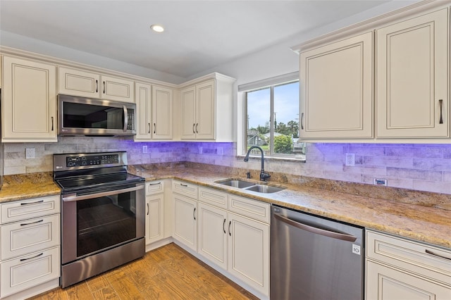 10 Venetian Cir, Port Orange, FL 32127 - kitchen featuring appliances with stainless steel finishes, tasteful backsplash, cream cabinets, light wood finished floors, and recessed lighting