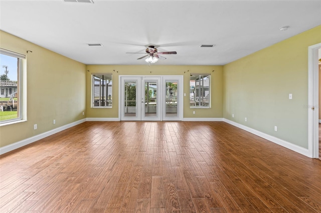10 Venetian Cir, Port Orange, FL 32127 - unfurnished living room featuring healthy amount of natural light, a ceiling fan, and wood finished floors