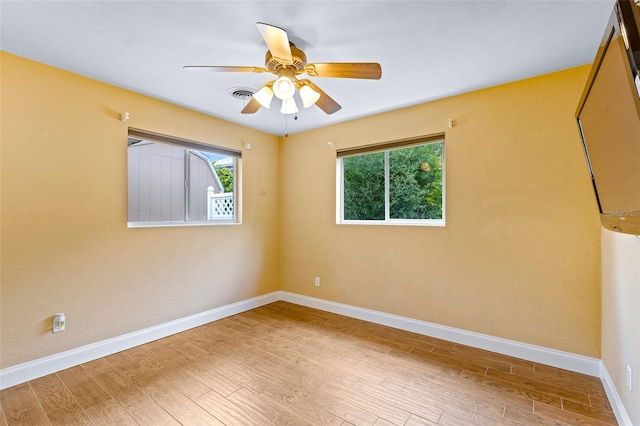 10 Venetian Cir, Port Orange, FL 32127 - spare room featuring healthy amount of natural light, wood finished floors, and ceiling fan