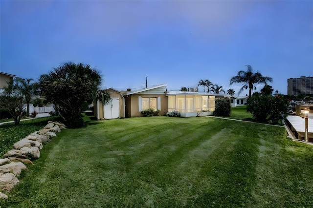 10 Venetian Cir, Port Orange, FL 32127 - rear view of property with a sunroom and a lawn