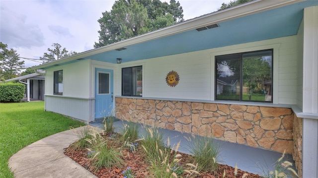 1017 Chippewa Trl, Daytona Beach, FL 32117 - view of front of home featuring stone siding and a front yard