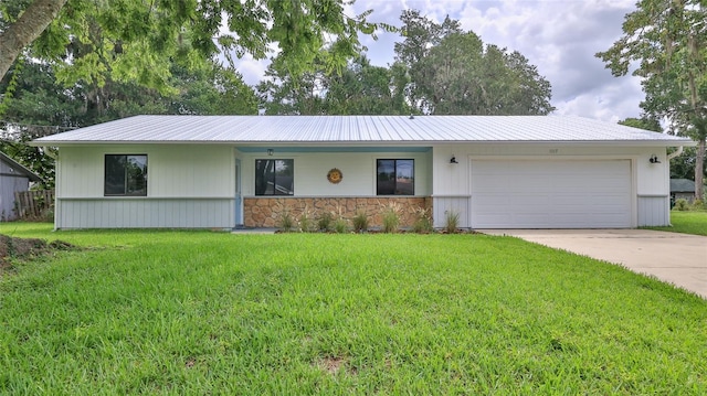 1017 Chippewa Trl, Daytona Beach, FL 32117 - single story home featuring an attached garage, a front yard, concrete driveway, and stone siding