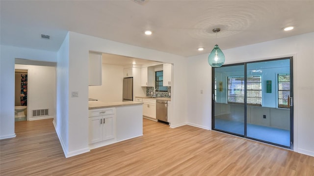 1017 Chippewa Trl, Daytona Beach, FL 32117 - kitchen featuring light wood-style floors, appliances with stainless steel finishes, white cabinets, light countertops, and recessed lighting