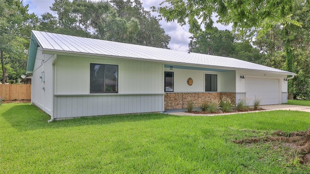 1017 Chippewa Trl, Daytona Beach, FL 32117 - ranch-style home featuring an attached garage, driveway, a metal roof, and stone siding