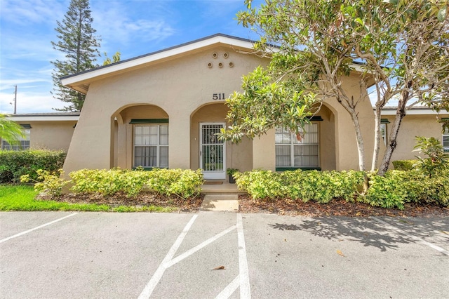 511 Polaris Loop Unit 105, Casselberry, FL 32707 - view of front facade with stucco siding and uncovered parking