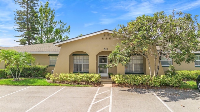 511 Polaris Loop Unit 105, Casselberry, FL 32707 - view of front of home with stucco siding and uncovered parking