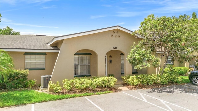 511 Polaris Loop Unit 105, Casselberry, FL 32707 - view of front of property featuring uncovered parking, stucco siding, and roof with shingles