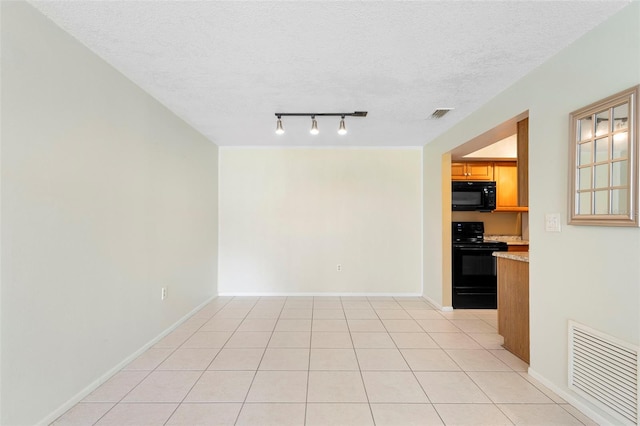 511 Polaris Loop Unit 105, Casselberry, FL 32707 - unfurnished room with a textured ceiling, rail lighting, and light tile patterned flooring