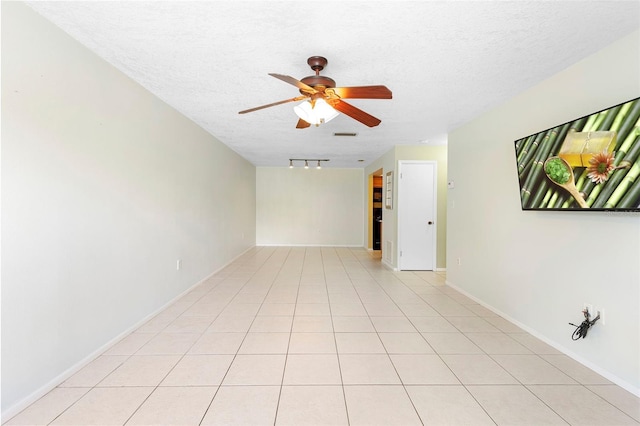 511 Polaris Loop Unit 105, Casselberry, FL 32707 - empty room featuring a ceiling fan, a textured ceiling, track lighting, and light tile patterned floors