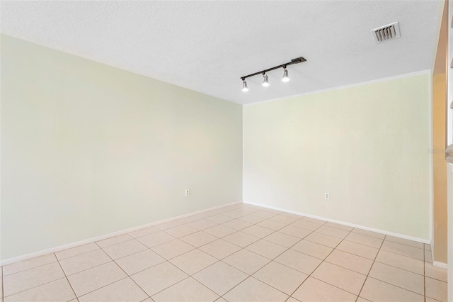 511 Polaris Loop Unit 105, Casselberry, FL 32707 - unfurnished room with track lighting, light tile patterned floors, and a textured ceiling