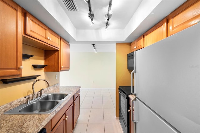 511 Polaris Loop Unit 105, Casselberry, FL 32707 - kitchen with freestanding refrigerator, track lighting, light tile patterned flooring, light countertops, and black range with electric stovetop