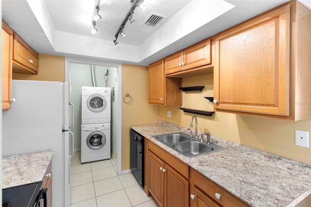 511 Polaris Loop Unit 105, Casselberry, FL 32707 - kitchen with stacked washer and clothes dryer, black appliances, light tile patterned floors, light countertops, and a raised ceiling