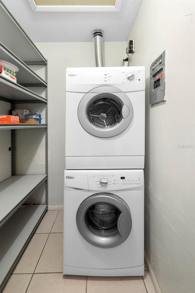 511 Polaris Loop Unit 105, Casselberry, FL 32707 - laundry room with stacked washer and clothes dryer and light tile patterned flooring