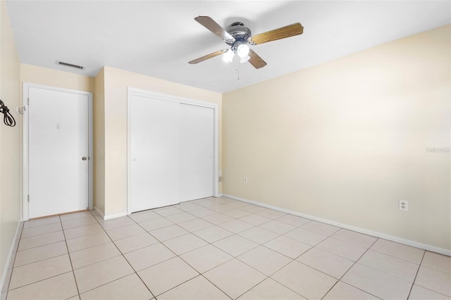 511 Polaris Loop Unit 105, Casselberry, FL 32707 - unfurnished bedroom with a closet, a ceiling fan, and light tile patterned floors