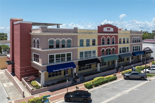 208 Wall St Unit 204, Daytona Beach, FL 32114 - view of building exterior featuring uncovered parking
