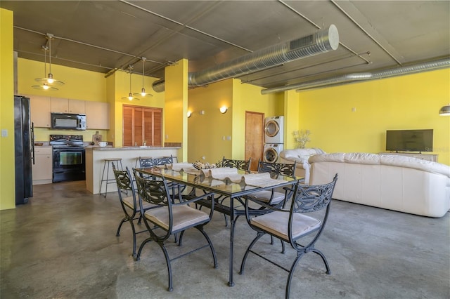 208 Wall St Unit 204, Daytona Beach, FL 32114 - dining room featuring concrete flooring and stacked washer / drying machine
