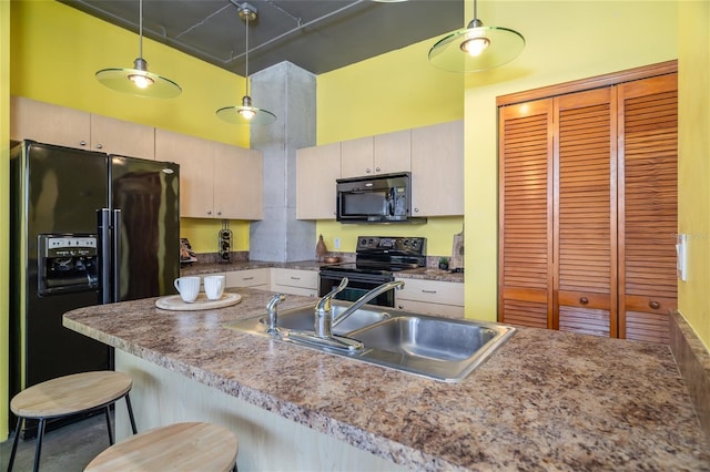 208 Wall St Unit 204, Daytona Beach, FL 32114 - kitchen featuring black appliances, a kitchen bar, decorative light fixtures, and a towering ceiling