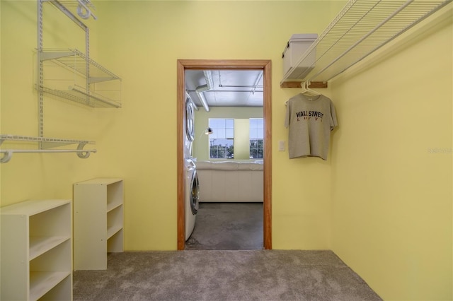 208 Wall St Unit 204, Daytona Beach, FL 32114 - spacious closet featuring attic access, stacked washer / dryer, and carpet