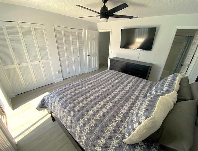 4786 S Atlantic Ave Unit 3, Ponce Inlet, FL 32127 - bedroom featuring wood finished floors, multiple closets, a textured ceiling, and ceiling fan