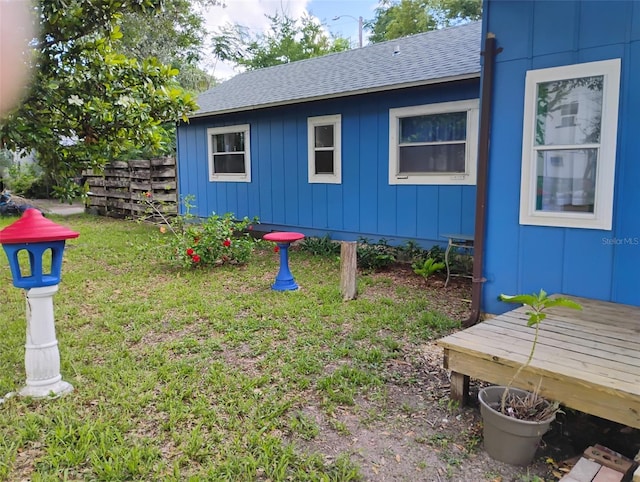 615 Weber Ave, Daytona Beach, FL 32114 - view of side of property featuring a shingled roof, board and batten siding, and a yard