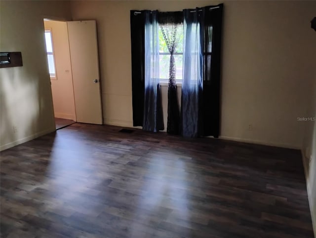 615 Weber Ave, Daytona Beach, FL 32114 - unfurnished room with dark wood-type flooring and healthy amount of natural light