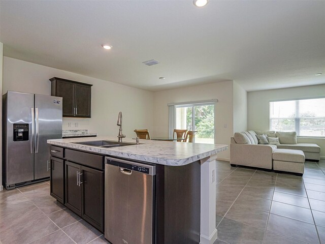 1915 Ganyard Ave SW, Palm Bay, FL 32908 - kitchen with appliances with stainless steel finishes, light tile patterned floors, open floor plan, light countertops, and dark brown cabinetry