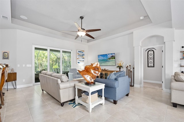 2825 S Asciano Ct, New Smyrna Beach, FL 32168 - living room with a tray ceiling, a ceiling fan, and light tile patterned floors