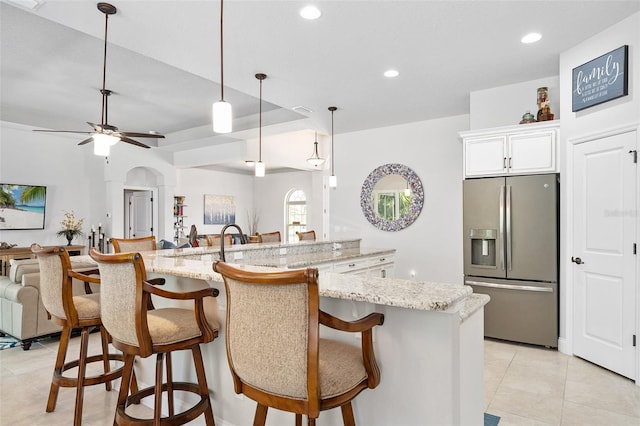 2825 S Asciano Ct, New Smyrna Beach, FL 32168 - kitchen with stainless steel fridge, open floor plan, light tile patterned flooring, recessed lighting, and a ceiling fan