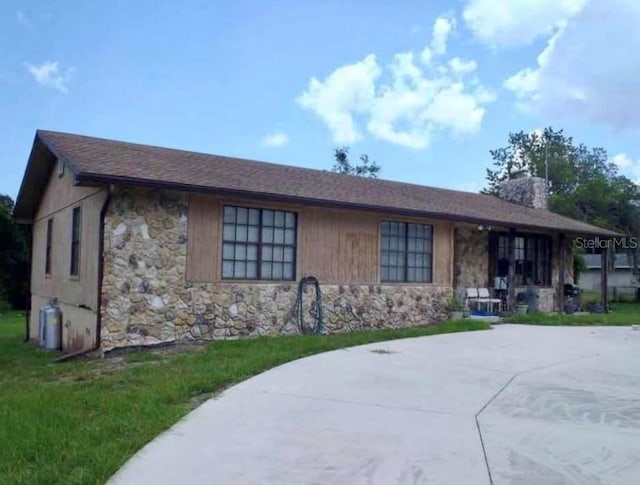 5759 Dogwood Rd, Port Orange, FL 32127 - ranch-style home with stone siding and a chimney