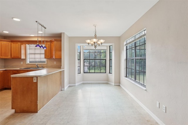 5759 Dogwood Rd, Port Orange, FL 32127 - kitchen featuring a chandelier, light countertops, a peninsula, pendant lighting, and recessed lighting