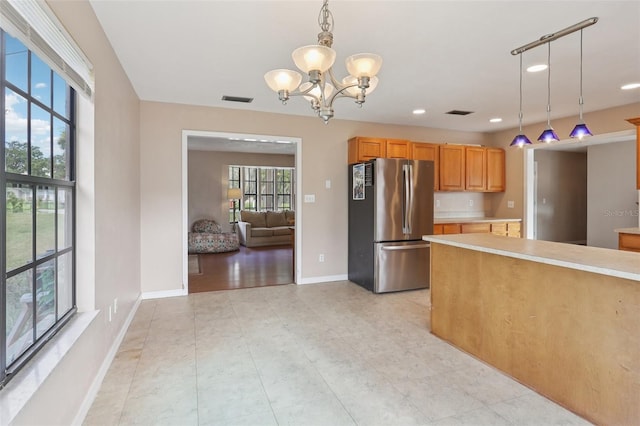 5759 Dogwood Rd, Port Orange, FL 32127 - kitchen with freestanding refrigerator, a chandelier, light countertops, pendant lighting, and recessed lighting