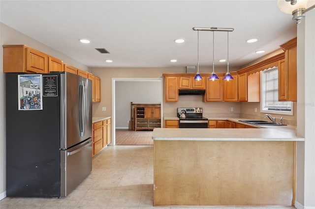5759 Dogwood Rd, Port Orange, FL 32127 - kitchen with appliances with stainless steel finishes, under cabinet range hood, a peninsula, light countertops, and pendant lighting