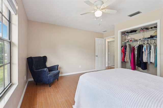 5759 Dogwood Rd, Port Orange, FL 32127 - bedroom with multiple windows, wood finished floors, a closet, and ceiling fan