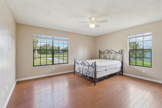 5759 Dogwood Rd, Port Orange, FL 32127 - bedroom featuring multiple windows, wood finished floors, and ceiling fan