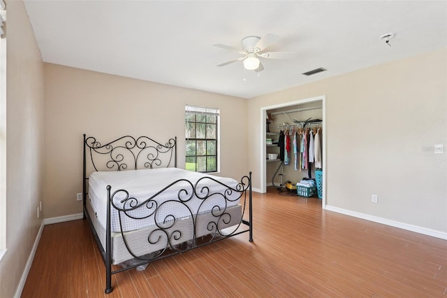 5759 Dogwood Rd, Port Orange, FL 32127 - bedroom featuring wood finished floors, a closet, a spacious closet, and a ceiling fan
