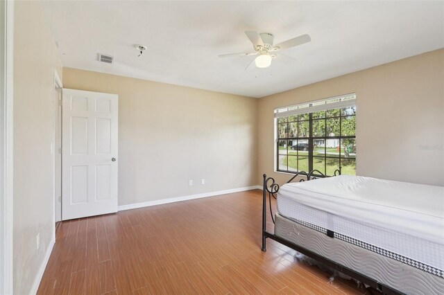 5759 Dogwood Rd, Port Orange, FL 32127 - bedroom with wood finished floors and a ceiling fan