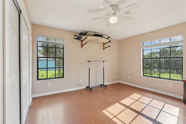 5759 Dogwood Rd, Port Orange, FL 32127 - unfurnished room featuring plenty of natural light, wood finished floors, and ceiling fan