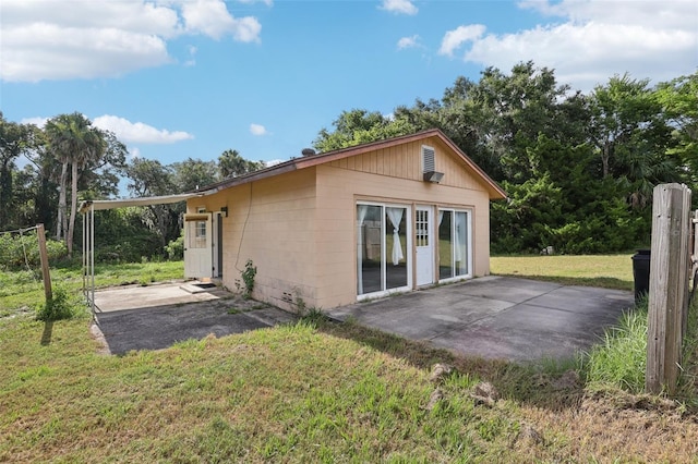 5759 Dogwood Rd, Port Orange, FL 32127 - rear view of property featuring a patio area, a yard, and concrete block siding
