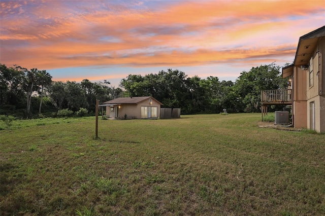 5759 Dogwood Rd, Port Orange, FL 32127 - yard at dusk featuring a lawn, an outdoor structure, and a wooden deck