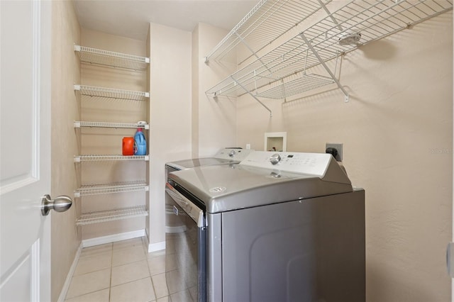 5759 Dogwood Rd, Port Orange, FL 32127 - washroom with washing machine and clothes dryer and light tile patterned floors