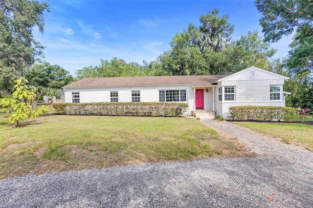 611 N Garfield Ave, Deland, FL 32724 - ranch-style house featuring a front lawn and driveway