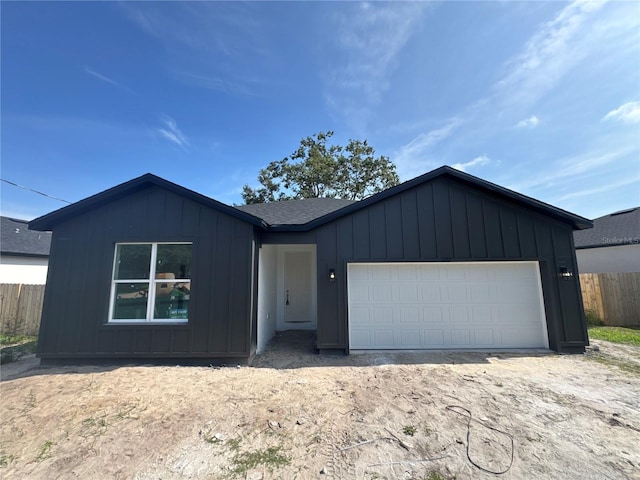 822 W 24th St, Sanford, FL 32771 - view of front of house with board and batten siding and a garage