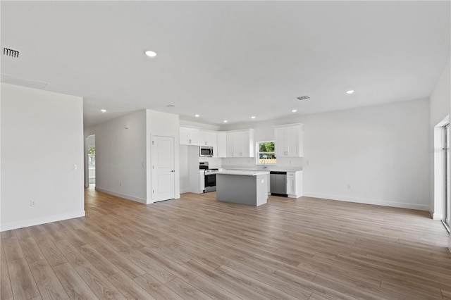 822 W 24th St, Sanford, FL 32771 - unfurnished living room with light wood-style flooring and recessed lighting