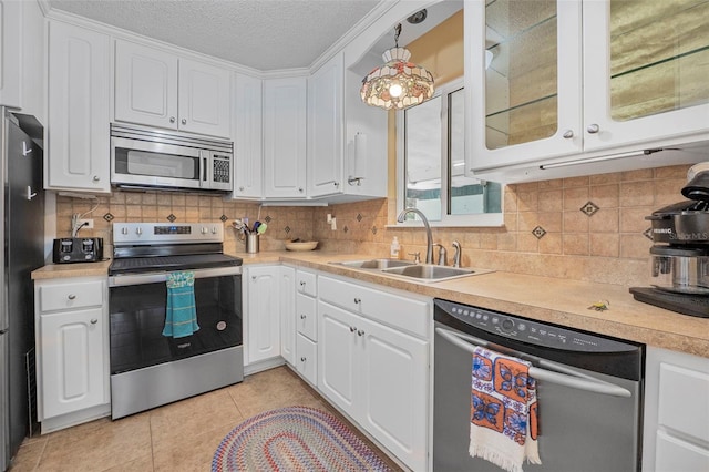 1085 Indigo Rd, Ormond Beach, FL 32174 - kitchen featuring appliances with stainless steel finishes, white cabinets, light countertops, and a textured ceiling